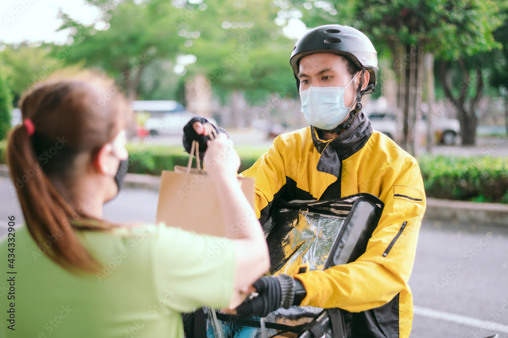 Male courier with bicycle delivered shopping yellow bag to the client.Courier delivery food service