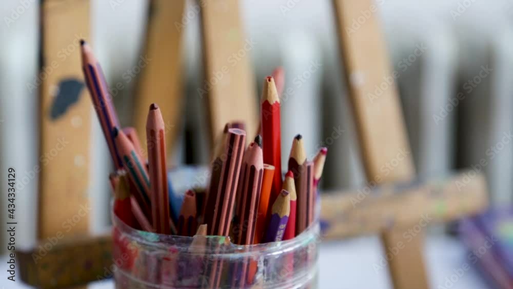 Soft pastel crayons in front of an easel Soft pastel crayons in front of an easel