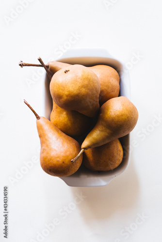 Fresh brown  pears over son a white background