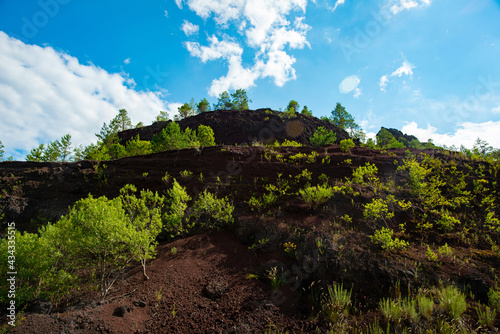 limestone cliffs from the old volcano and green vegetation in the middle of the plain