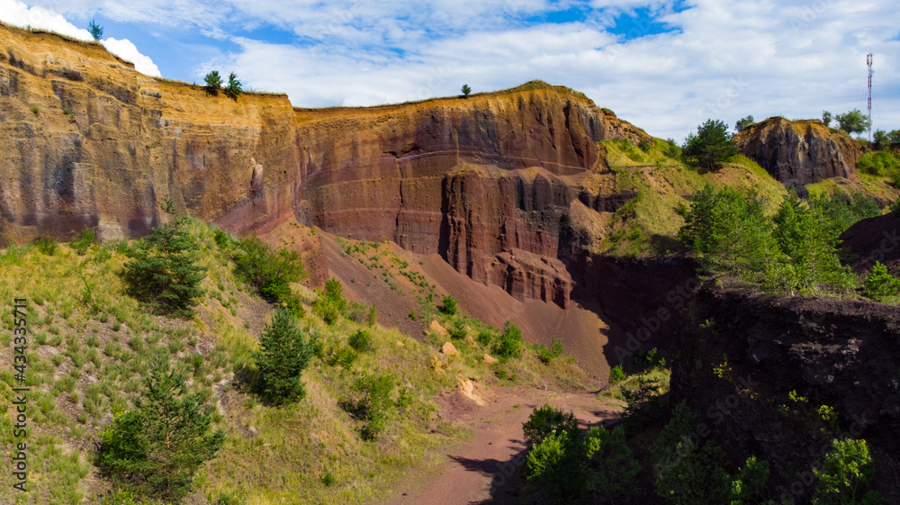 limestone cliffs from the old volcano and green vegetation in the middle of the plain