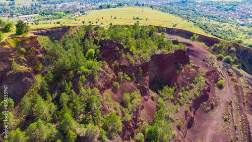 limestone cliffs from the old volcano and green vegetation in the middle of the plain