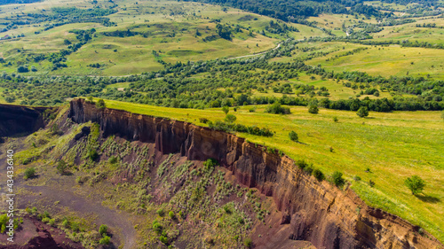 limestone cliffs from the old volcano and green vegetation in the middle of the plain