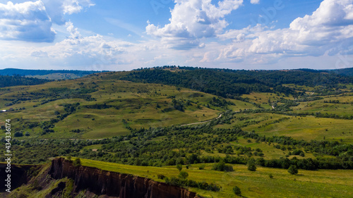 limestone cliffs from the old volcano and green vegetation in the middle of the plain