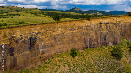 limestone cliffs from the old volcano and green vegetation in the middle of the plain