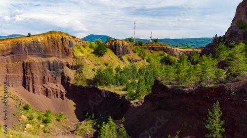 limestone cliffs from the old volcano and green vegetation in the middle of the plain
