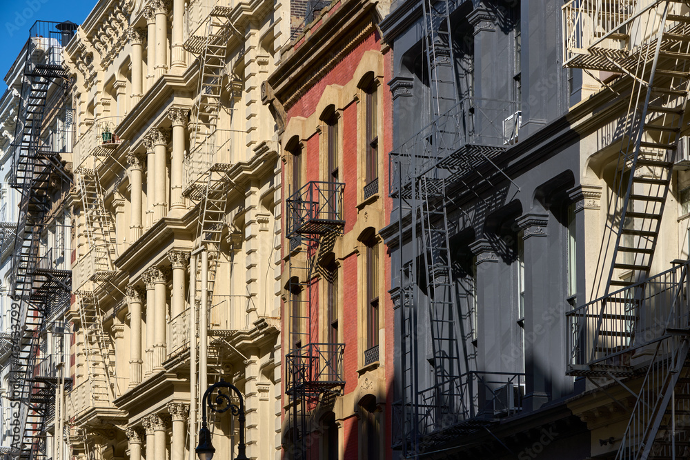 Typical building facades in SoHo, the Cast Iron Historic District with distinct late 19th century architecture. Lower Manhattan, New York City, USA