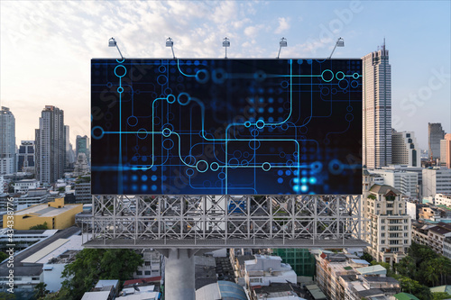 Glowing hologram of technological process on billboard, aerial panoramic cityscape of Bangkok at sunset. The largest innovative hub of tech services in Southeast Asia.