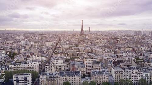 Paris and Eiffel Tower aerial panorama, with view of Haussmann buildings and roofs at sunrise. Beautiful tourism destination for summer vacation in French Capital city. 4k video footage 60fps.