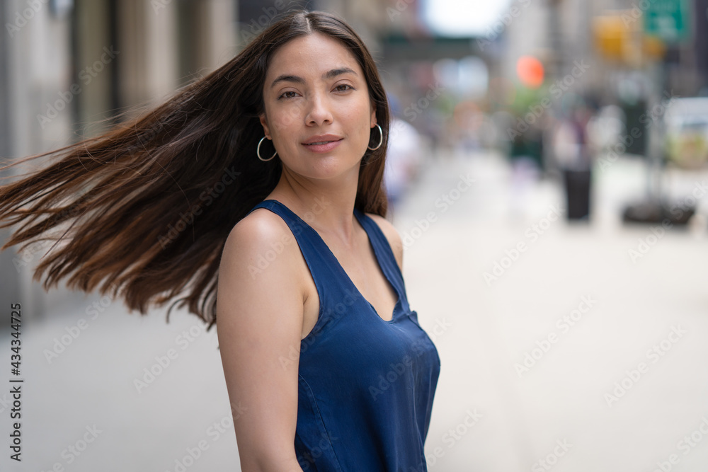 Young Latina Hispanic woman turning head long hair waving