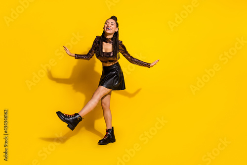 Full length photo of young excited african girl happy positive smile have fun excited isolated over yellow color background