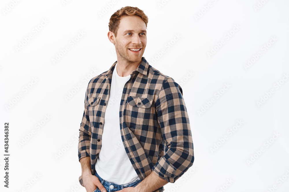 Attractive caucasian man with strong masculine body and red hair, looking over his shoulder at promotional banner, turn head right at copyspace logo, standing over white background Attractive caucasian man with strong masculine body and red hair, looking over his shoulder at promotional banner, turn head right at copyspace logo, standing over white background