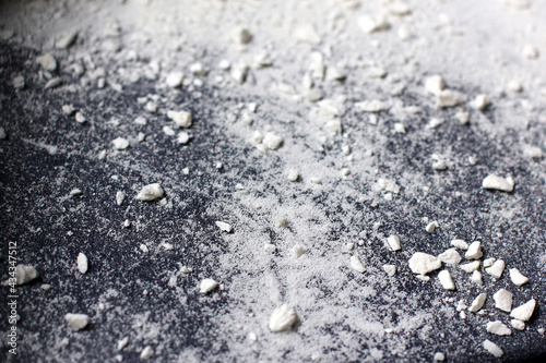 White dust. White powder. Scattering white particles. Abstract background