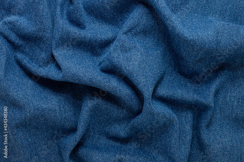 texture of crumpled blue denim close up. background for your mockup