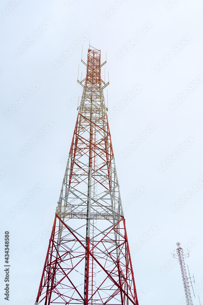 workers are working at 5g antenna tower for maintaining.serves cellular antenna, technician worker repair telecommunication tower on sunlight at background. workers are working at 5g antenna tower for maintaining.serves cellular antenna, technician worker repair telecommunication tower on sunlight at background.
