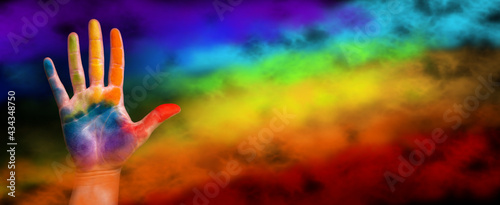 Gay pride concept. The hand is painted with a rainbow. Gay pride lgbt b rainbow flag photo