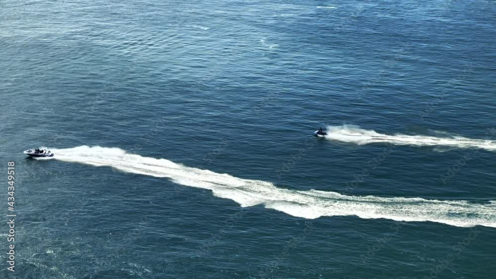 Thrill seekers having fun off the coast and racing jet and speed boats Thrill seekers having fun off the coast and racing jet and speed boats
