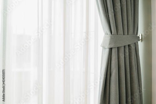Glass window with white translucent curtain.Close up sheer curtain with beautiful sunlight in the morning
