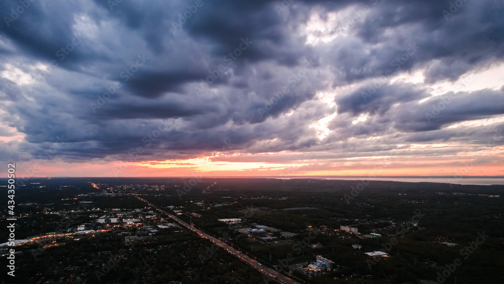 Obraz premium Sunset and clouds over town.