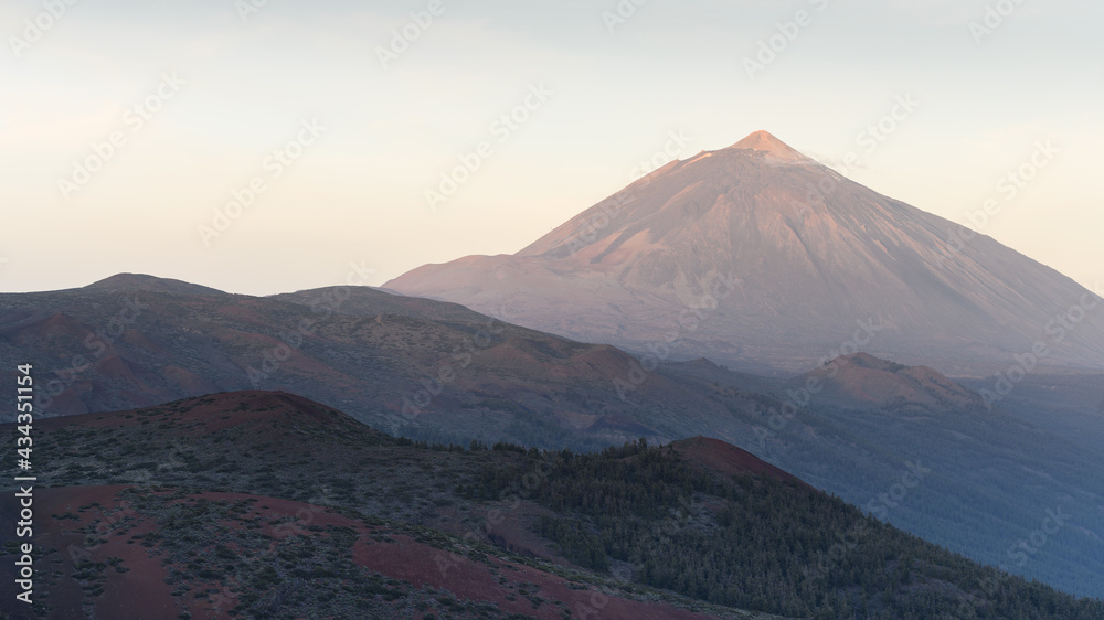 Teide volcano at Tenerife during sunrise with hills