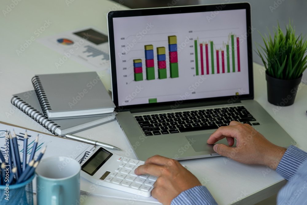 Financial Business Man analyze the graph of the company's performance to create profits and growth, Market research reports and income statistics, Financial and Accounting concept. Financial Business Man analyze the graph of the company's performance to create profits and growth, Market research reports and income statistics, Financial and Accounting concept.