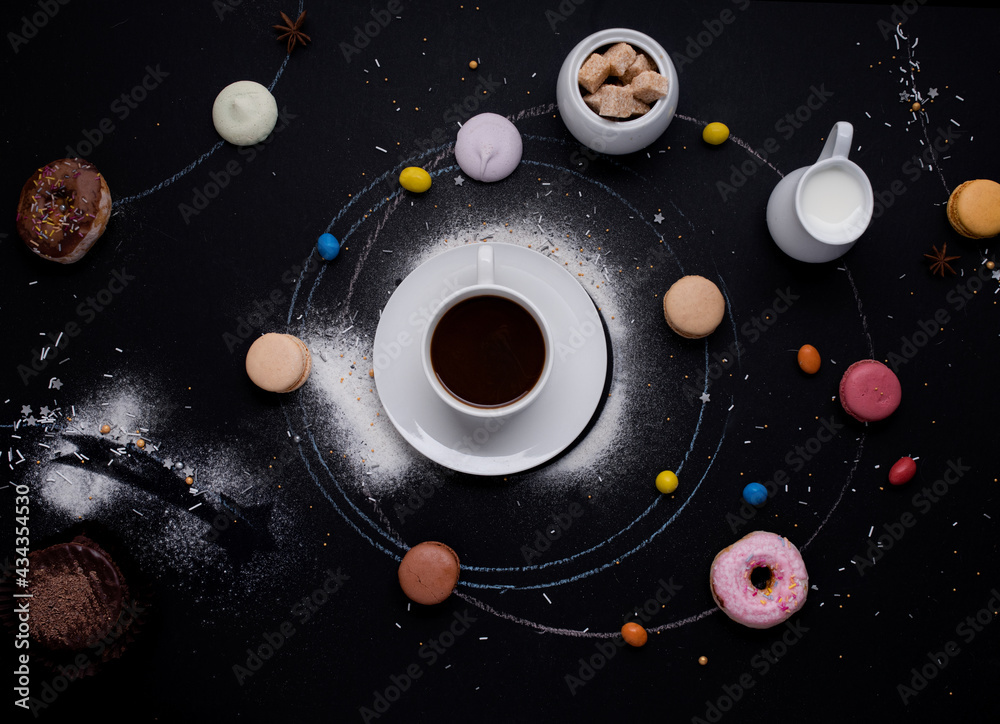 cup of coffee, donuts, macaroons, sugar, milk cream jug and cakes on the black background look like coffee system cup of coffee, donuts, macaroons, sugar, milk cream jug and cakes on the black background look like coffee system