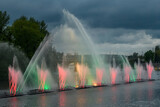 Evening view to Musical fountain with laser animations Roshen on the Southern Buh river in Vinnytsia, Ukraine. May 2021