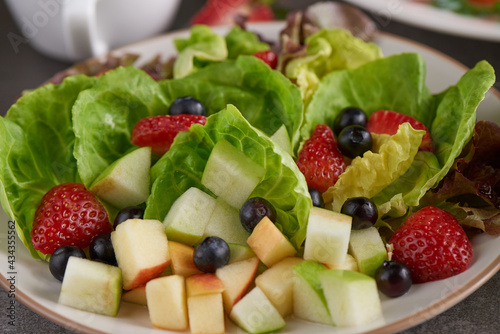 top view mix fruit and vegetable salad on white dish. .Healthy vegetable salad. Diet menu. Top view.