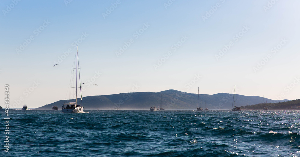 Several yachts sailing in the sea near the town of Trogir - Croatia Several yachts sailing in the sea near the town of Trogir - Croatia