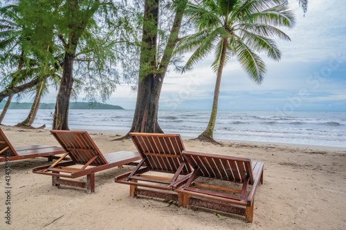 Wooden chair beside the beach with beautiful idyllic seascape view on kohkood island.Koh Kood  also known as Ko Kut  is an island in the Gulf of Thailand