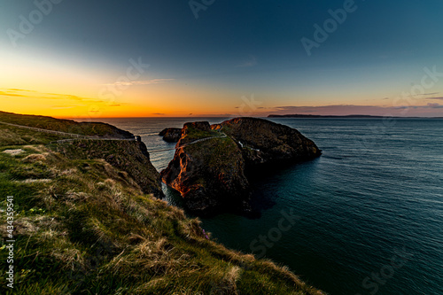 Sunset at Carrick a Rede rope bridge, Ballintoy, Causeway coast and Glens, County Antrim, Northern Ireland