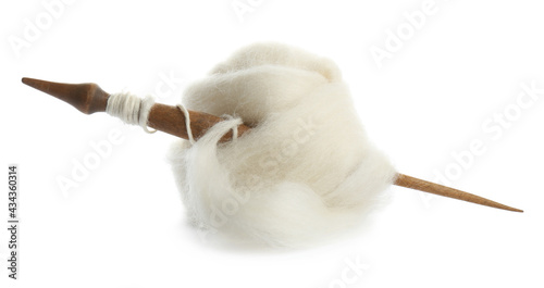 Ball of combed wool with wooden spindle isolated on white photo