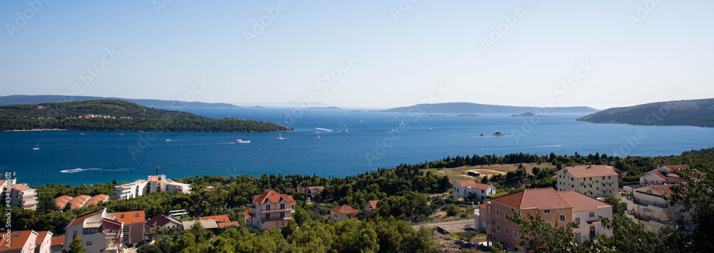 View of the sea bay near Trogir in Croatia from a mountain road. Many yachts move on the sea