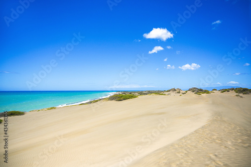Desert landscape with sea near in Domican republic. Las Salinas  dunes. Travelling destination.