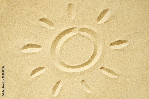 sun drawn in sand, summer beach holidays