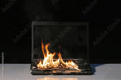 Burning laptop computer photo