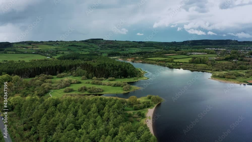 Aerial view over Irish landscape in spring the Baltyboys area, County Wicklow, revealing forest, lake, and hills. Aerial view over Irish landscape in spring the Baltyboys area, County Wicklow, revealing forest, lake, and hills.