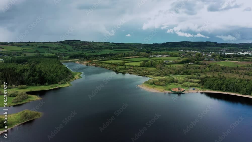 Aerial view over Irish landscape in spring the Baltyboys area, County Wicklow, revealing forest, lake, and hills. Aerial view over Irish landscape in spring the Baltyboys area, County Wicklow, revealing forest, lake, and hills.