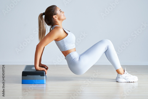 Fotografie Adult beautiful woman working using stepper out over light background