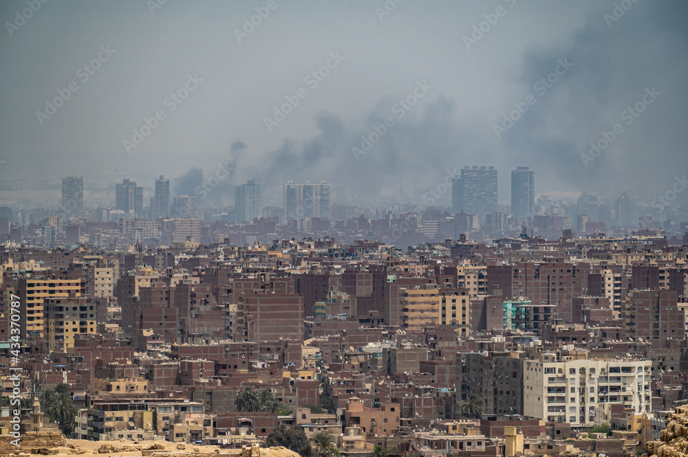 Pollution over Cairo city. smog, smoke, fog, over an Arab city. problem of air pollution. aerial view of misty of city of Cairo in Egypt, due to traffic pollution, over rooftop slums