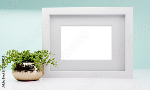 Room with a plant and empty frame