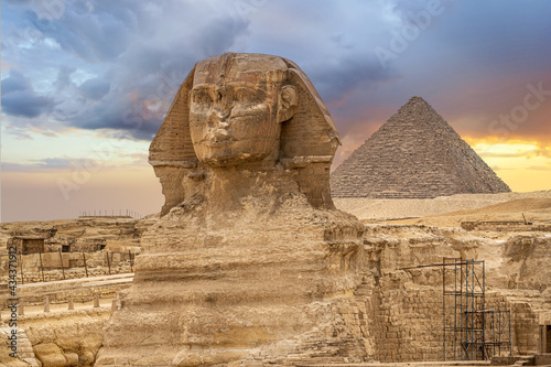 Great sphinx and pyramids. Egypt Cairo. Landscape with Egyptian pyramids, Great Sphinx and silhouettes Ancient symbols and landmarks of Egypt in golden sunlight. Sphinx in Giza pyramid complex