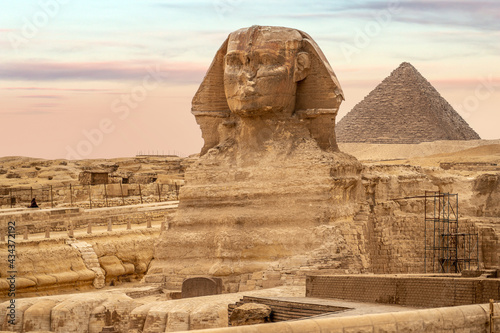 General view of pyramids with Sphinx. The Sphinx and the Piramids  famous Wonder of the World  Giza  Egypt. incredible view of the face of the Sphinx and the great pyramid. travel background