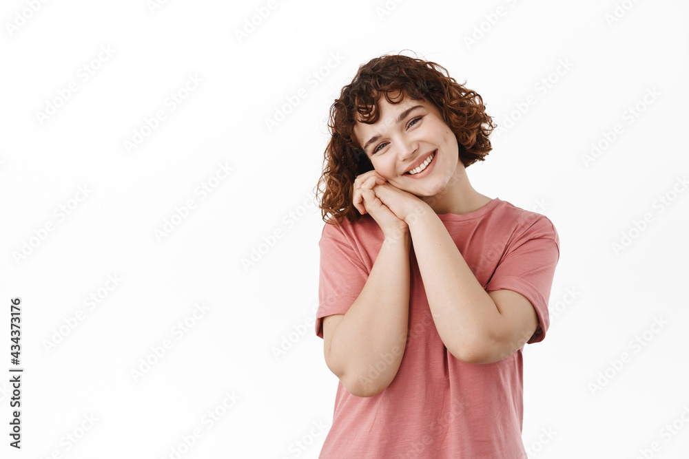 How lovely. Smiling cute curly girl, leaning on palms and sighing cute, gazing at something lovely and beautiful, admire something, daydreaming with romantic face, white background
