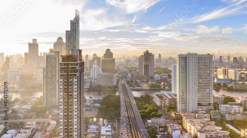 Bangkok traffic toward downtown during rush hour on Taksin bridge over Chao Phraya river in morning - time lapse