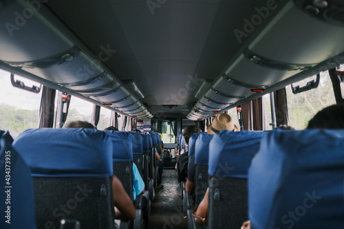 Interior of a bus with passengers seated in modern bus seats