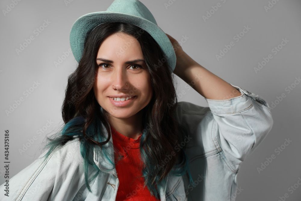 Beautiful young woman with nose piercing on grey background Beautiful young woman with nose piercing on grey background