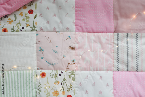 Pink patchwork blanket. Baby bedding. Bedding and textile for nursery. Nap and sleep time photo