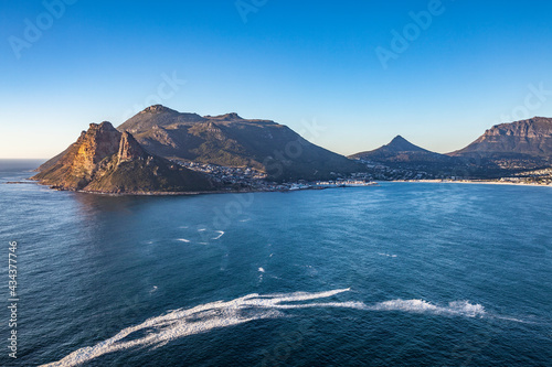 panaramic view on Hout Bay, the southern Harbor of Cape Town, with characteristic table cloth clouds rolling over the mountains,South Africa, landscape
 photo
