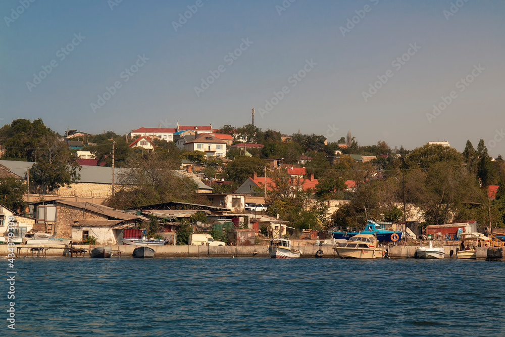 A view of a Sevastopol bay coact from a deck of ship. Houses on slope by the sea